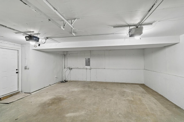 garage featuring a garage door opener and electric panel