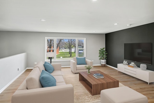 living room featuring light wood-type flooring, recessed lighting, and baseboards