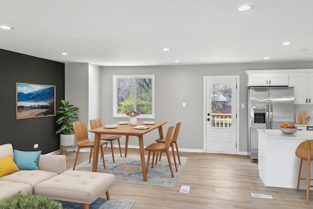 dining space with recessed lighting, visible vents, light wood-style floors, and baseboards