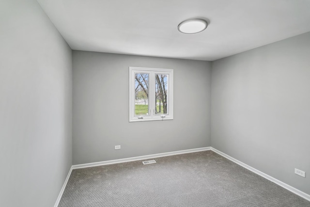 unfurnished room with baseboards, visible vents, and carpet flooring