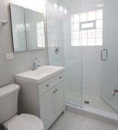 full bathroom with toilet, vanity, and a stall shower