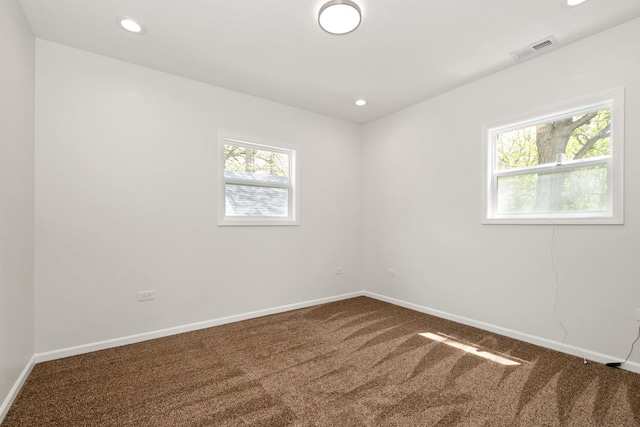empty room featuring carpet, baseboards, and recessed lighting