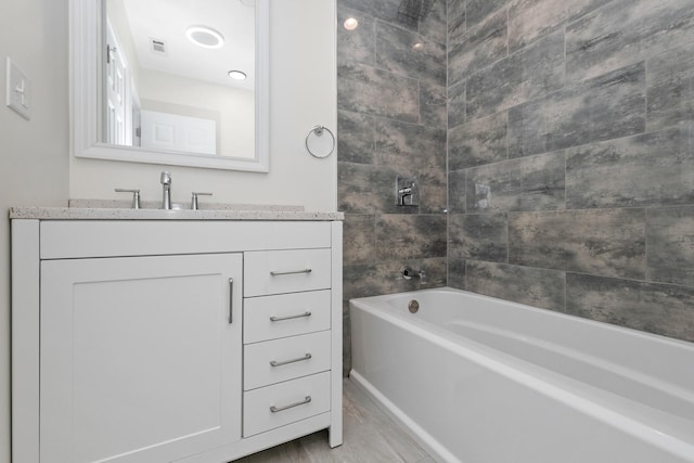 bathroom with vanity, shower / bath combination, and marble look tile flooring