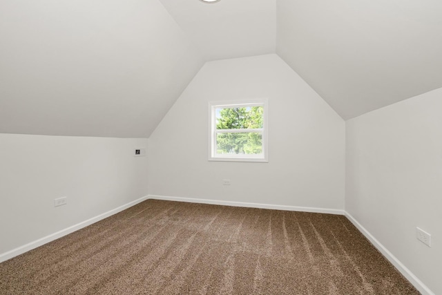 bonus room with carpet floors, baseboards, and vaulted ceiling