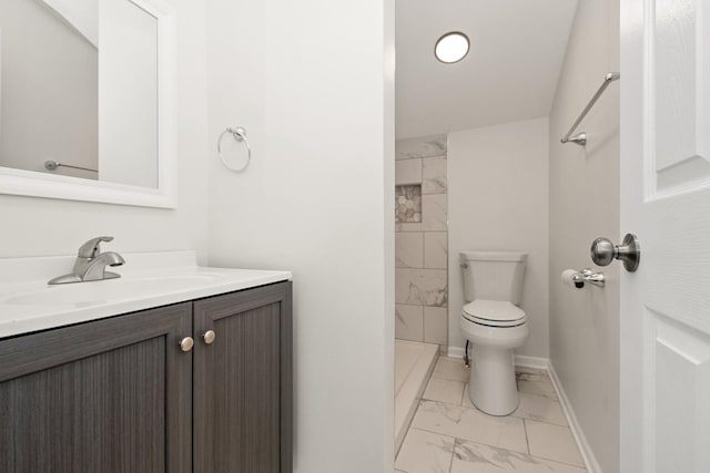 bathroom featuring marble look tiles, toilet, vanity, a shower, and baseboards