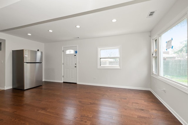 foyer with dark wood finished floors, recessed lighting, and baseboards