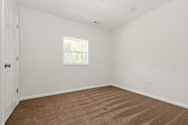 unfurnished room featuring carpet floors and baseboards