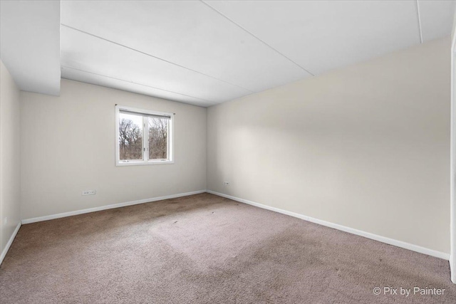 empty room with carpet floors and baseboards