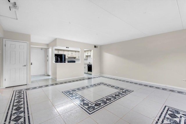 unfurnished living room with baseboards and visible vents