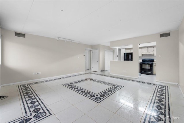 unfurnished living room featuring track lighting, baseboards, and visible vents