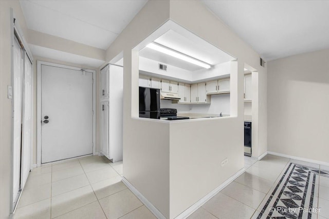 kitchen featuring light tile patterned flooring, visible vents, under cabinet range hood, and black appliances