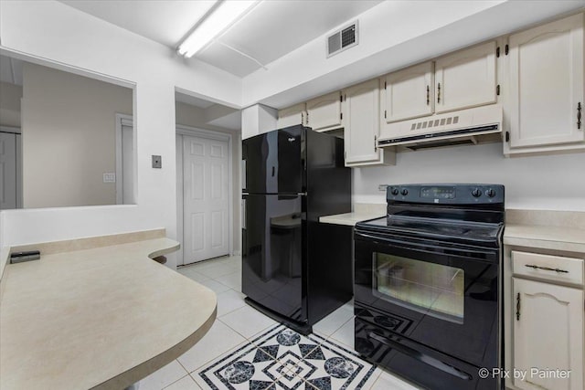 kitchen featuring extractor fan, black appliances, light tile patterned floors, light countertops, and visible vents