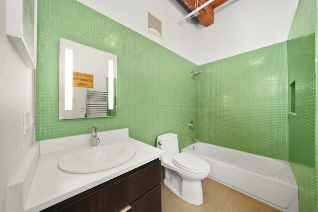 full bath featuring toilet, tile walls, shower / bath combination, tile patterned flooring, and vanity
