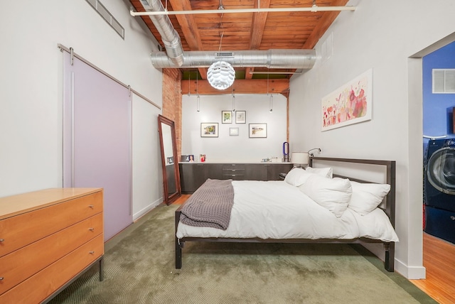 carpeted bedroom with washer / clothes dryer and visible vents