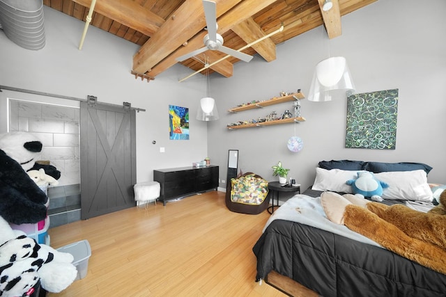 bedroom with a barn door, wood finished floors, beam ceiling, and wooden ceiling