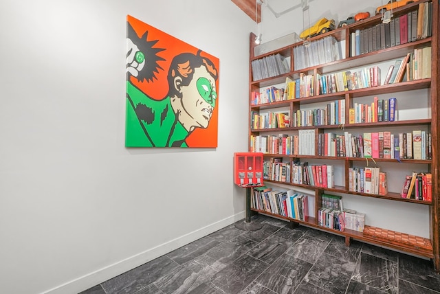 interior space featuring marble finish floor and baseboards