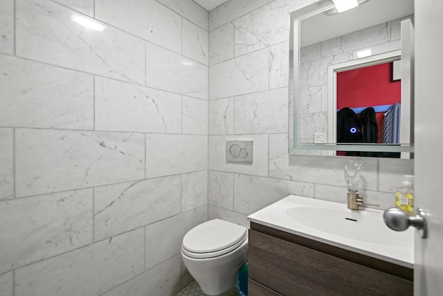 bathroom featuring tile walls, toilet, and vanity