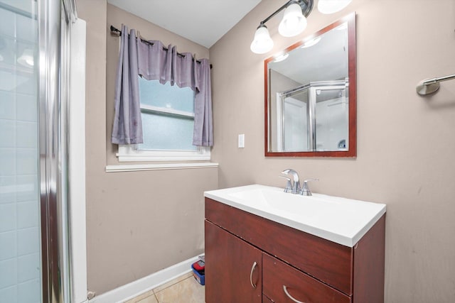 bathroom with a shower stall, tile patterned flooring, and vanity