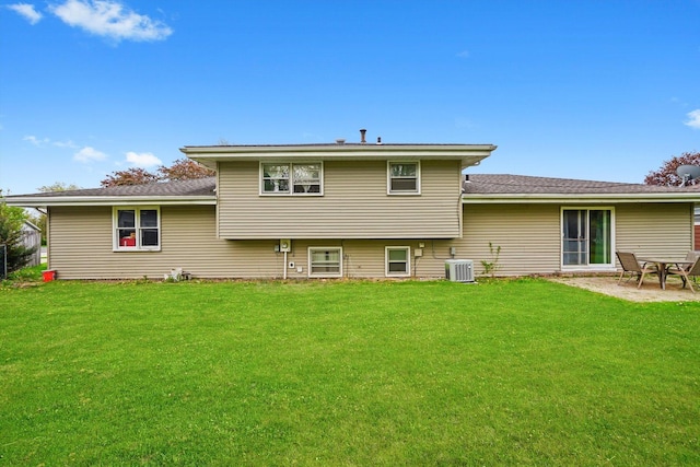 rear view of property featuring central air condition unit, a patio, and a yard