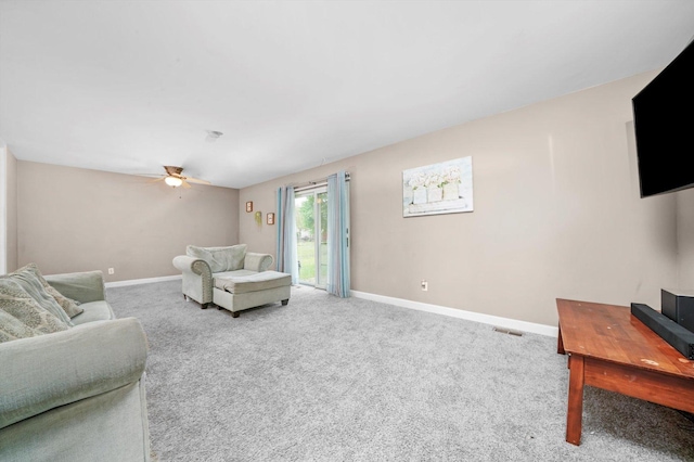carpeted living room with baseboards, ceiling fan, and visible vents