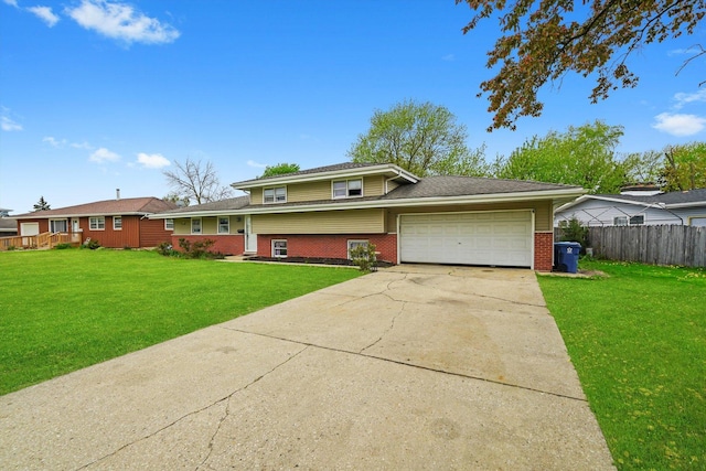 split level home featuring driveway, a garage, brick siding, fence, and a front lawn