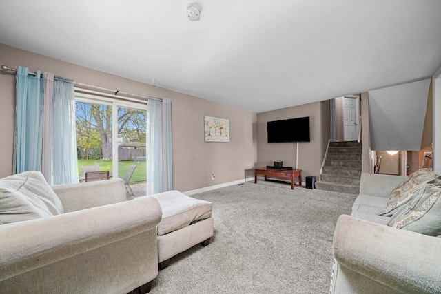 living room with stairway, baseboards, and carpet