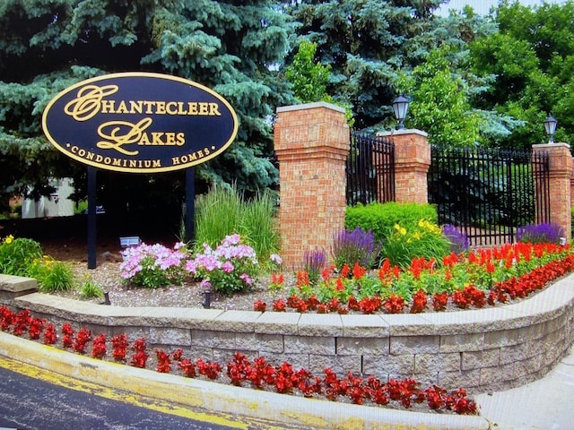 community / neighborhood sign with fence