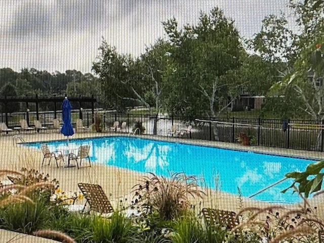community pool featuring fence