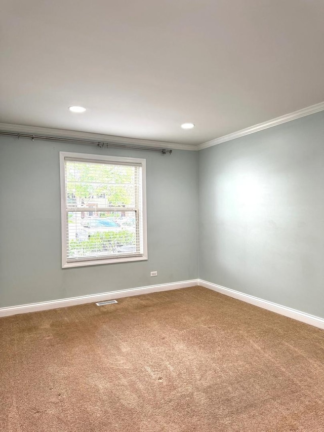 unfurnished room with carpet floors, crown molding, baseboards, and recessed lighting