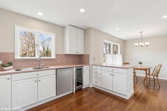 910 Lane, Lorraine, Lake Forest, IL 60045 - kitchen with stainless steel dishwasher, a healthy amount of sunlight, a sink, and dark wood-type flooring