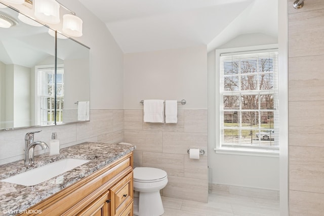 910 Lane, Lorraine, Lake Forest, IL 60045 - bathroom featuring vaulted ceiling, vanity, tile walls, a healthy amount of sunlight, and toilet