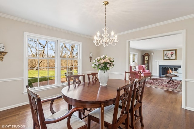 910 Lane, Lorraine, Lake Forest, IL 60045 - dining space featuring dark wood-style floors, a warm lit fireplace, crown molding, baseboards, and a notable chandelier