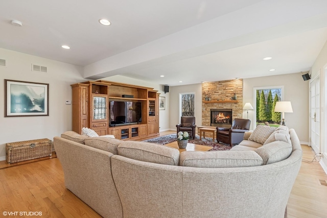 910 Lane, Lorraine, Lake Forest, IL 60045 - living room with baseboards, a stone fireplace, visible vents, and light wood-type flooring
