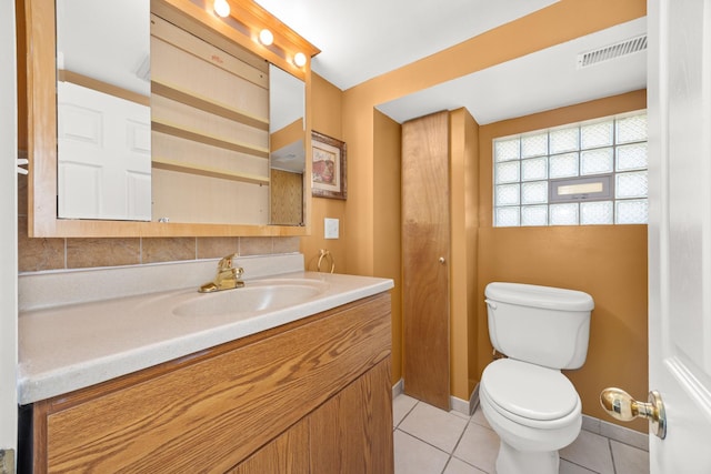 bathroom with toilet, tile patterned floors, vanity, and visible vents