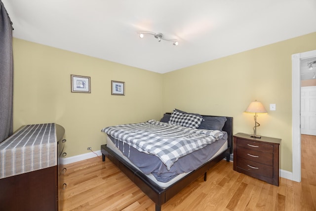 bedroom featuring light wood-style floors and baseboards