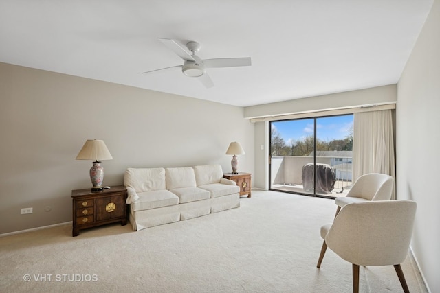 living area with carpet floors and a ceiling fan