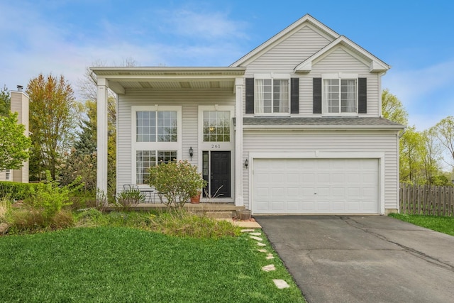 view of front of house with a garage, fence, a front yard, and aphalt driveway