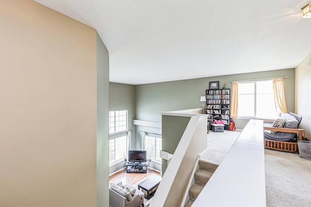 stairway featuring carpet flooring and visible vents