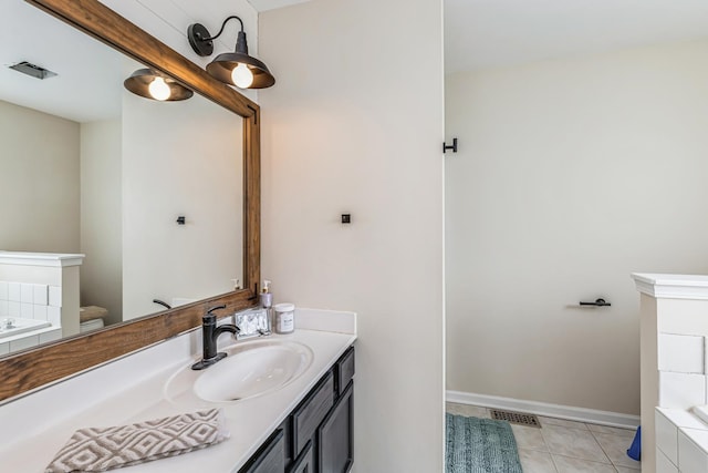 bathroom featuring vanity, tile patterned flooring, a garden tub, and visible vents