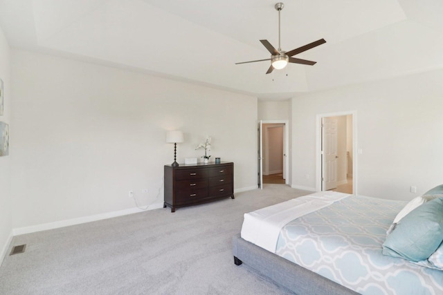 bedroom featuring lofted ceiling, visible vents, light carpet, baseboards, and ceiling fan