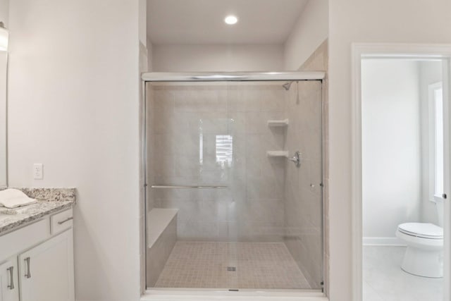 bathroom featuring toilet, recessed lighting, tile patterned flooring, a shower stall, and vanity