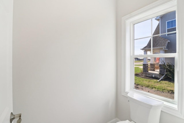 bathroom with toilet and baseboards