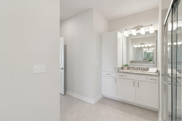 full bathroom featuring baseboards, tile patterned flooring, vanity, and a stall shower