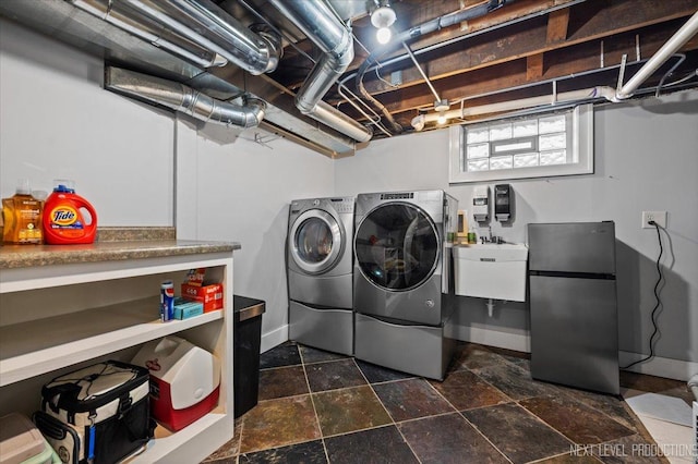 349 N Lincoln St, Batavia, IL 60510 - laundry room with laundry area, a sink, washing machine and dryer, stone finish flooring, and baseboards