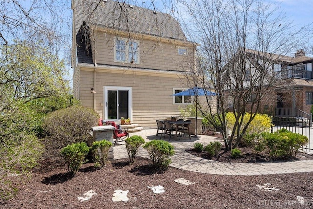 349 N Lincoln St, Batavia, IL 60510 - back of property with fence, a patio, and a shingled roof