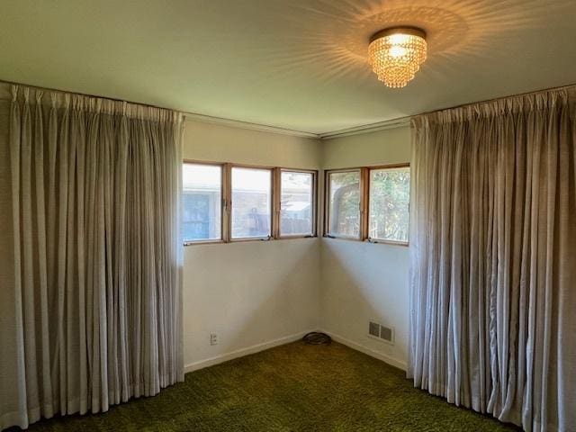 carpeted empty room with baseboards and visible vents