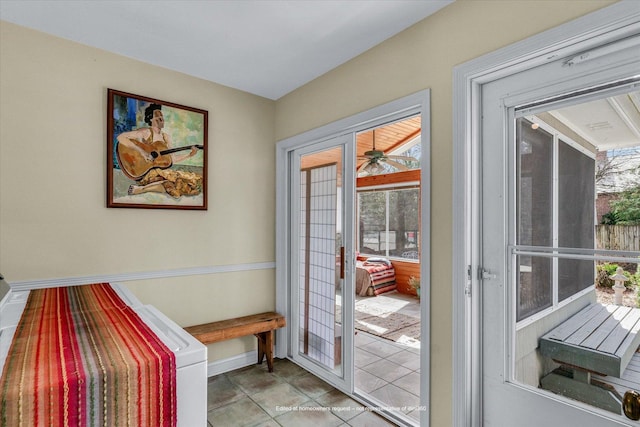 entryway with baseboards and light tile patterned floors