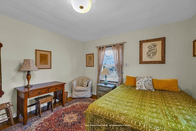 bedroom featuring baseboards and wood finished floors