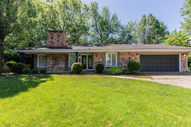 854 Kings Cv, Princeton, IL 61356 - ranch-style house with brick siding, a garage, french doors, driveway, and a front lawn