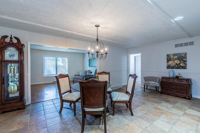 854 Kings Cv, Princeton, IL 61356 - dining space with a chandelier, light stone finish flooring, baseboards, and a textured ceiling